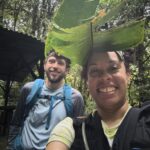 Mercedes Burns and Ryan Bacon wearing banana leaves as hats.